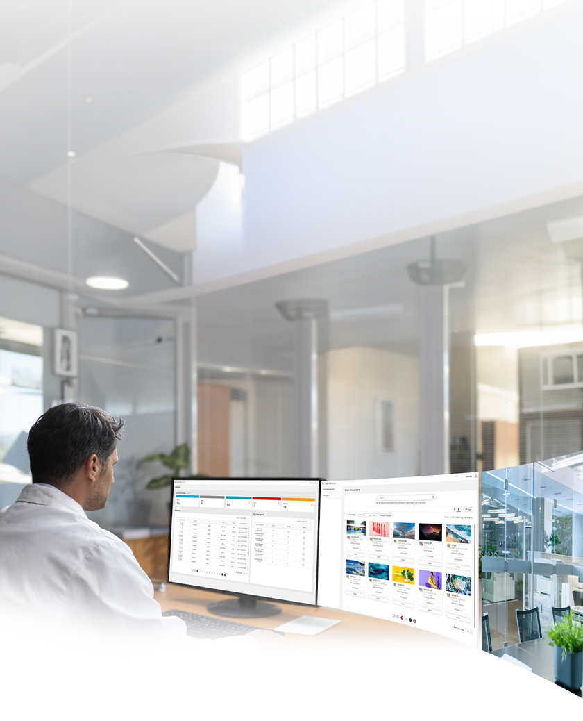 An IT administrator is monitoring devices while viewing the dashboard and equipment management screen of the LG SuperSign Control+ solution.