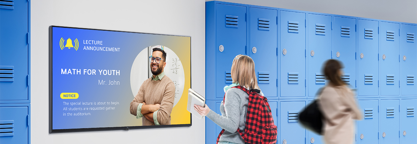 This image depicts a student viewing content on a digital signage screen in the school hallway. The displayed notification says, 'MATH FOR YOUTH'(special session for math), instructing students to gather in the lecture hall.