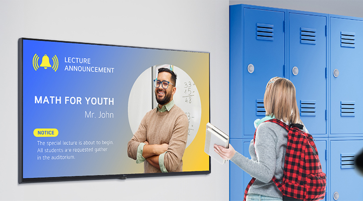 This image depicts a student viewing content on a digital signage screen in the school hallway. The displayed notification says, 'MATH FOR YOUTH'(special session for math), instructing students to gather in the lecture hall.