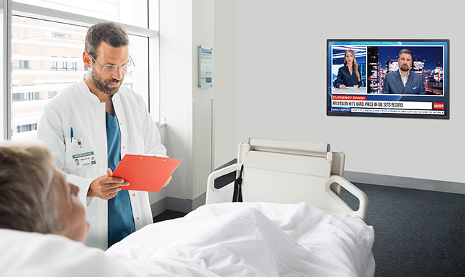 An LG commercial TV is installed in a hospital room.